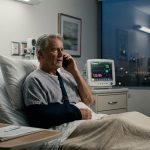 Injured father making a hospital phone call after his son ignored 97 calls while vacationing in the Maldives