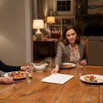 Mother reviewing an $85,000 home expansion proposal presented by her daughter during Sunday dinner