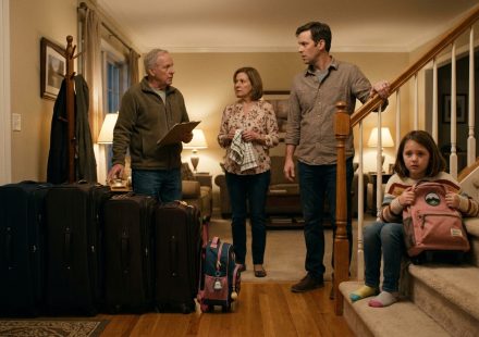 Eight-year-old Mia holding her packed travel bag after being asked to give up her spot on the family vacation