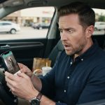 Shocked husband looking at a baby monitor app after he caught my wife cheating in their child's room.