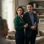 A worried woman standing beside her fiancé while her narcissistic older sister watches them from inside the family home.