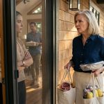 A 64-year-old woman carrying groceries while her daughter-in-law blocks her from entering her own lakehouse.