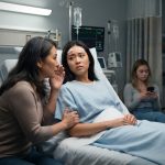 Injured young woman in a hospital bed as her mother pressures her and a doctor enters with her brain scans.
