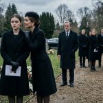 Sophia and her stepmother facing each other At My Grandfather's Funeral while the family lawyer watches nearby.