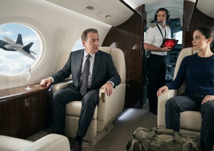 Woman sits calmly inside her rich uncle's luxury private jet as a worried pilot holds a red security screen and an F-22 appears outside.