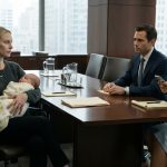 New mother holding her 12-day-old baby during a divorce meeting while her husband sits across the table beside his mistress