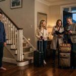 Young man standing in the entryway as his parents and sister leave with luggage for Europe