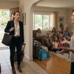 A woman arrives with her suitcase expecting to care for her sick mother but finds her healthy family gathered inside the house.