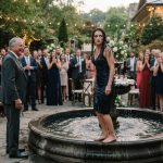 Waverly standing soaked beside a wedding fountain after her father pushed her into the water in front of laughing wedding guests.