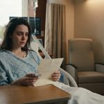 A 28-year-old woman who woke up from a coma sitting alone in a hospital bed while looking at a note left beside her.