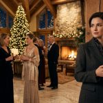 Claire standing inside a luxury Christmas hotel while her family mocked her hotel career
