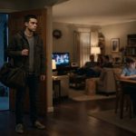 An 18-year-old young man quietly leaving his family home at night with a packed bag while his family remains unaware inside.