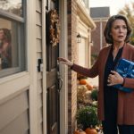 A grandmother holding a blue birthday present overhears her daughter-in-law through an open window before her grandson's birthday party.