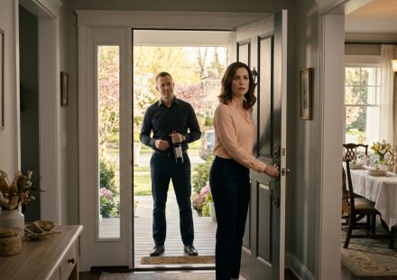 A woman faces her uninvited brother holding a bottle of wine at the front door of her Easter-decorated family home.