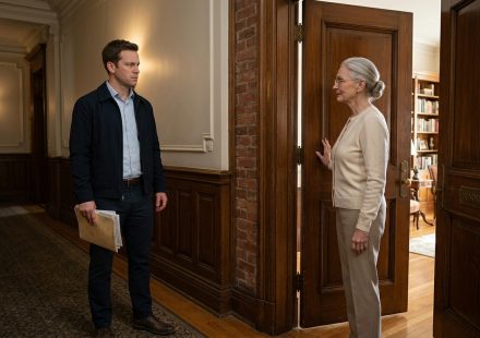 Carter Fisher standing outside his inherited apartment building with property manager Linda Benson as they discuss a mysterious tenant.
