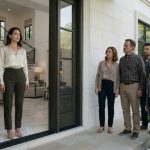 Natalie calmly opens the door of her mansion as her estranged family stands outside in surprise.