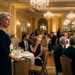 A shocked mother seated away from the head table as her son and new daughter-in-law make an unexpected announcement during their wedding reception.