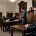 A composed woman sits alone at a courtroom defence table while her parents and their attorney accuse her of falsifying her military service.