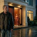 An elderly father wearing a rain-soaked jacket stands outside his wealthy daughter's luxurious Seattle home after being refused shelter.