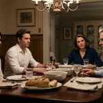 A young woman sitting silently beside her fiancé at an elegant family dinner while her father makes a shocking accusation and her mother looks on.