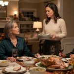 Mother at a tense Thanksgiving dinner telling her daughter to start paying her own bills