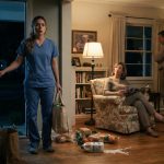 Olivia arriving home with groceries and finding her parents unexpectedly sitting inside her first house late at night.
