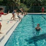 Lifeguard Told Me Not to Move as I floated alone in a deep swimming pool while other swimmers evacuated and a mysterious shadow moved underwater.