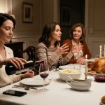 A composed woman pours red wine during Thanksgiving dinner while her sister enthusiastically discusses plans to move into her privately owned beach house.