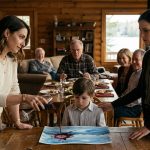 A six-year-old boy watches his aunt pour red wine over his watercolor painting at a family gathering while his mother looks on in disbelief.