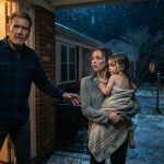 Father opening his door as his daughter arrives holding his soaked three-year-old granddaughter on a freezing December night