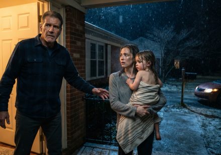 Father opening his door as his daughter arrives holding his soaked three-year-old granddaughter on a freezing December night
