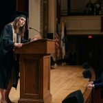 A young woman collapsed at my graduation ceremony scene, losing her balance at the podium as shocked graduates and audience members watch.